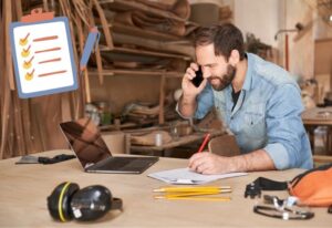 artisan au téléphone avec ordinateur et lise à puces